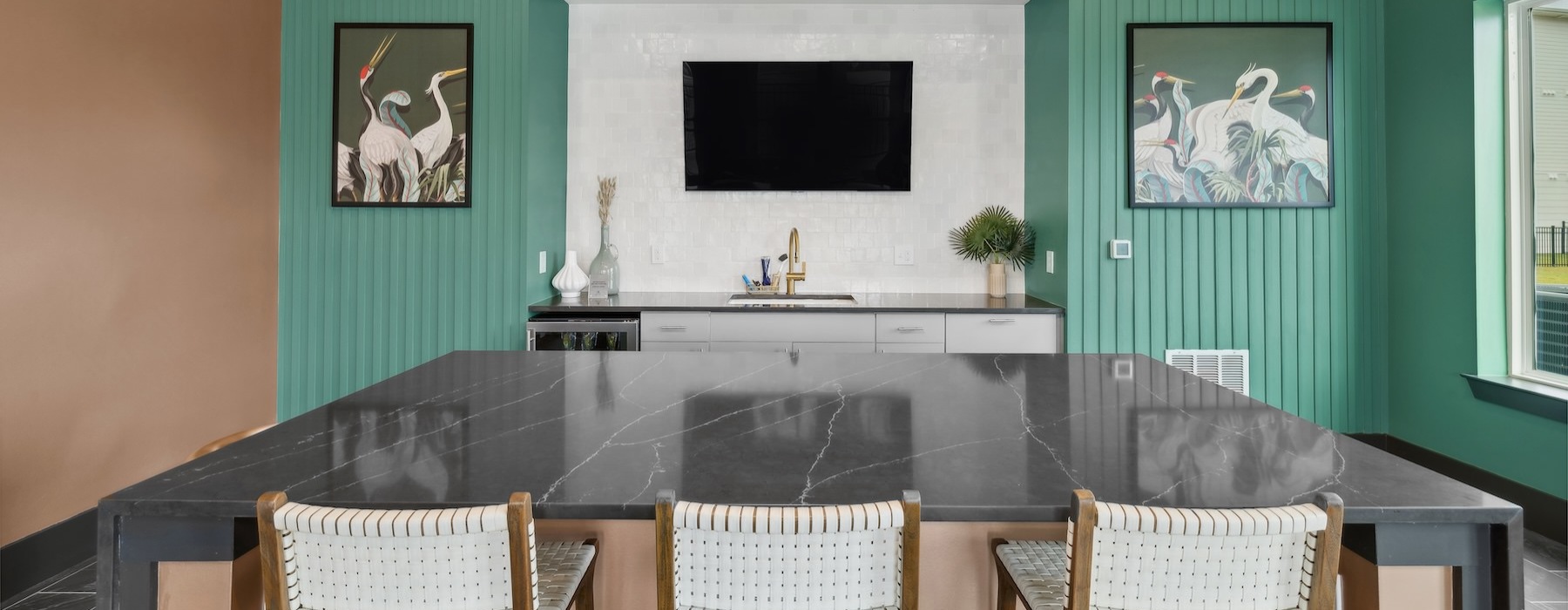 a clubroom kitchen with a large island and chairs