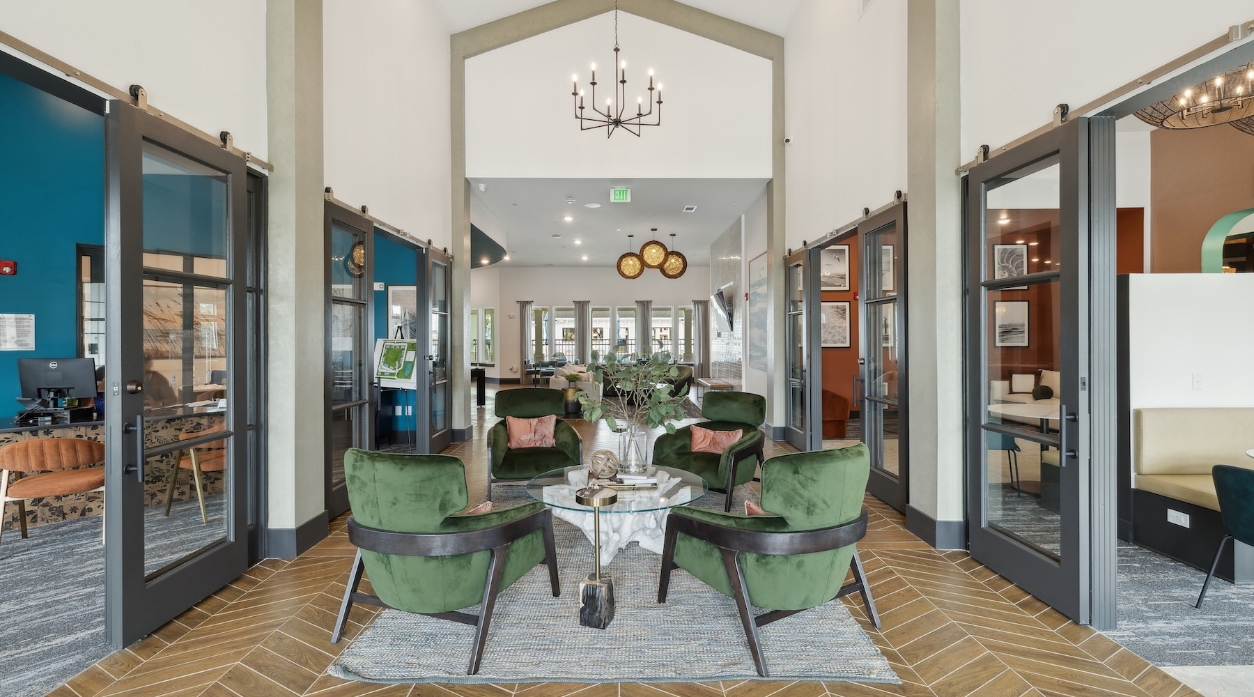 a clubroom with open glass doors, chairs and tables