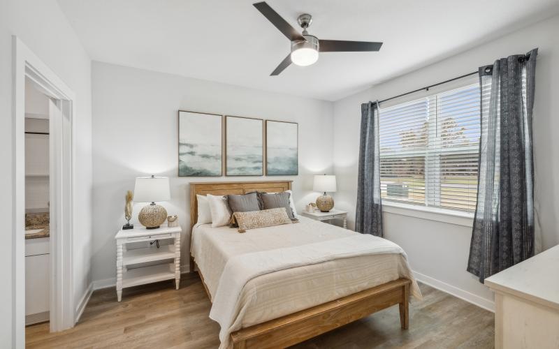 a bedroom with a bed and a fan