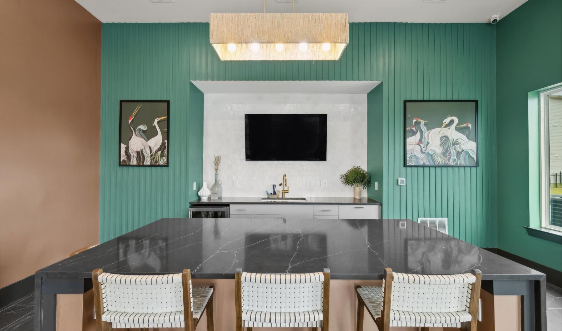 a clubroom kitchen with a large island and chairs